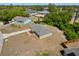 Aerial view of a gray home with landscaping, a driveway, and a well-manicured lawn at 17147 Sw 42Nd Ct, Ocala, FL 34473