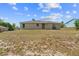 Rear exterior view of a single story home with a spacious backyard and green grass at 17147 Sw 42Nd Ct, Ocala, FL 34473