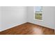 A simple bedroom showcasing wood floors and a window for natural light at 17147 Sw 42Nd Ct, Ocala, FL 34473