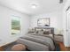 Cozy bedroom featuring a large window and comfortable furnishings at 17147 Sw 42Nd Ct, Ocala, FL 34473