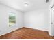Bright bedroom with wood flooring and a window providing natural light at 17147 Sw 42Nd Ct, Ocala, FL 34473