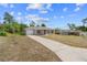 Beautiful home with a long driveway, neutral siding, and well-manicured lawn at 17147 Sw 42Nd Ct, Ocala, FL 34473
