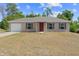 Charming single-story home featuring a front-facing garage and a well-maintained lawn at 17147 Sw 42Nd Ct, Ocala, FL 34473