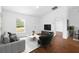 Bright living room with a large window, hardwood floors, and comfortable seating at 17147 Sw 42Nd Ct, Ocala, FL 34473