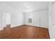 A bright, unfurnished room featuring wood floors, white walls, and a window with a view at 17147 Sw 42Nd Ct, Ocala, FL 34473