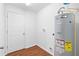 Utility room featuring water heater and laundry hookups, ideal for storage and functionality at 17147 Sw 42Nd Ct, Ocala, FL 34473