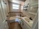 Bright bathroom featuring tiled walls, a bathtub, and a vanity with storage at 21135 Sw Honeysuckle St, Dunnellon, FL 34431