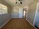 Cozy bedroom with ceiling fan, neutral walls, and natural light at 21135 Sw Honeysuckle St, Dunnellon, FL 34431