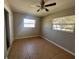 Bedroom with ceiling fan, two windows, and neutral walls at 21135 Sw Honeysuckle St, Dunnellon, FL 34431