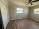 Bedroom featuring wood-look flooring, a ceiling fan, and natural light at 21135 Sw Honeysuckle St, Dunnellon, FL 34431