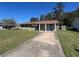 Charming single-story home features a long driveway and mature landscaping at 21135 Sw Honeysuckle St, Dunnellon, FL 34431