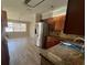 Open kitchen and dining area features stainless steel appliances and wood cabinets at 21135 Sw Honeysuckle St, Dunnellon, FL 34431