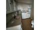 Functional laundry room with sink, cabinets, and appliances, maximizing space at 21135 Sw Honeysuckle St, Dunnellon, FL 34431