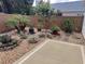 Serene backyard retreat featuring decorative stone, custom planting and accent lighting at 3154 Merrit Ln, The Villages, FL 32163