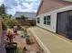 Backyard featuring well-maintained landscaping with patio, shrubbery, and decorative stones at 3154 Merrit Ln, The Villages, FL 32163
