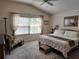 Primary bedroom featuring a large window with curtains, a comfortable seating area and decor at 3154 Merrit Ln, The Villages, FL 32163