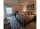 Cozy bedroom with neutral walls, comfortable queen sized bed and natural light at 3154 Merrit Ln, The Villages, FL 32163