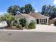 Charming single-story home featuring mature landscaping, a spacious driveway and inviting front porch seating at 3154 Merrit Ln, The Villages, FL 32163