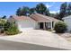 Beautiful one-story home with a two-car garage, an extra long driveway, and inviting front porch seating at 3154 Merrit Ln, The Villages, FL 32163