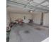 Spacious two car garage with painted walls, exposed ceiling, and two entry doors at 3154 Merrit Ln, The Villages, FL 32163