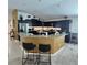 Modern kitchen featuring sleek dark cabinets, granite countertops, and bar seating at 3154 Merrit Ln, The Villages, FL 32163
