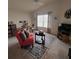 Bright living room with modern furnishings, TV, area rug and lots of light at 3154 Merrit Ln, The Villages, FL 32163
