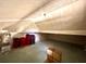 Spacious attic offering ample storage, featuring carpeted floors and neutral wall paneling at 4145 Se 3Rd St, Ocala, FL 34471