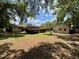 Large backyard with mature trees and a shed, offering ample space for outdoor activities at 4145 Se 3Rd St, Ocala, FL 34471