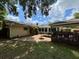 Backyard featuring a covered deck and a stone patio, perfect for outdoor entertaining at 4145 Se 3Rd St, Ocala, FL 34471