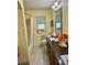 Well-lit bathroom with a single sink vanity and a shower-tub combination at 4145 Se 3Rd St, Ocala, FL 34471