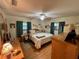 Bright bedroom with a queen-sized bed, two windows, and hardwood floors at 4145 Se 3Rd St, Ocala, FL 34471