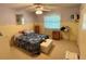 Bright bedroom with a comfortable bed, decorative accents, and a large window at 4145 Se 3Rd St, Ocala, FL 34471