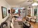 Open-concept living area with comfortable seating and an adjacent kitchen with lots of natural light at 4145 Se 3Rd St, Ocala, FL 34471