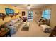 Bright and airy living room featuring comfortable seating, decorative items, and a large window at 4145 Se 3Rd St, Ocala, FL 34471
