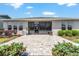 Inviting backyard with a stone patio, tidy landscaping, and a screened-in porch for outdoor enjoyment at 4379 Nw 56Th Ct, Ocala, FL 34482