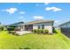 Well-manicured backyard showcasing a lush lawn, paver patio, and beautiful landscaping for outdoor enjoyment at 4379 Nw 56Th Ct, Ocala, FL 34482