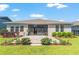 Serene backyard with lush lawn, brick patio, and manicured landscaping perfect for outdoor living at 4379 Nw 56Th Ct, Ocala, FL 34482