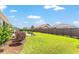 Beautiful backyard with green lawn, flowerbeds, and a modern fence, creating a peaceful outdoor oasis at 4379 Nw 56Th Ct, Ocala, FL 34482