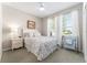 Cozy bedroom featuring a comfortable bed, two windows, and stylish decor elements at 4379 Nw 56Th Ct, Ocala, FL 34482