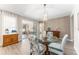 Dining area with a glass table, decorative chairs, and a view into other rooms at 4379 Nw 56Th Ct, Ocala, FL 34482