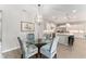 Dining area featuring a glass-top table, decorative chairs, and a stylish chandelier at 4379 Nw 56Th Ct, Ocala, FL 34482