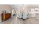 Dining area with glass table, decorative chairs, and modern chandelier, flowing into the kitchen at 4379 Nw 56Th Ct, Ocala, FL 34482