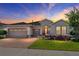 Charming single-story home boasts a three-car garage, arched entryway, and beautifully landscaped front yard at 4379 Nw 56Th Ct, Ocala, FL 34482