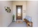 Inviting front porch features a decorative plant, bronze wall art, bench, and an impressive front door at 4379 Nw 56Th Ct, Ocala, FL 34482