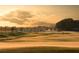 Breathtaking sunrise view of the golf course featuring a dew-kissed green and a flag at 4379 Nw 56Th Ct, Ocala, FL 34482