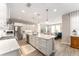 Bright kitchen features white cabinetry, a center island with pendant lighting, and stainless steel appliances at 4379 Nw 56Th Ct, Ocala, FL 34482