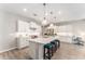Bright kitchen boasts white cabinetry, a center island with pendant lighting, and stainless steel appliances at 4379 Nw 56Th Ct, Ocala, FL 34482