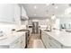 Bright kitchen features white cabinetry, a center island with pendant lighting, and stainless steel appliances at 4379 Nw 56Th Ct, Ocala, FL 34482