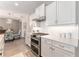 Bright kitchen featuring white cabinetry, stainless steel appliances, and tile backsplash at 4379 Nw 56Th Ct, Ocala, FL 34482
