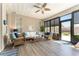 Inviting lanai features wicker furniture, ceiling fan, and view of the backyard at 4379 Nw 56Th Ct, Ocala, FL 34482